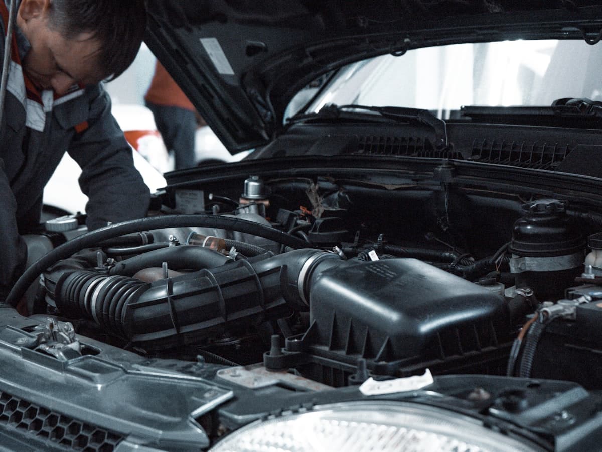 Mechanic inspecting a vehicle in a professional garage